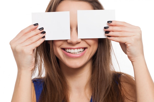 Beautiful young woman close eyes with card