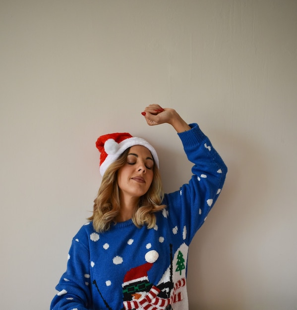 Beautiful young woman in cute blue Christmas outfit