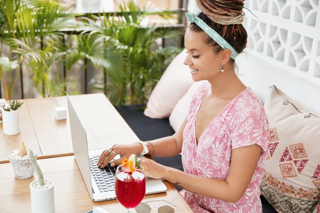 Beautiful young woman in dress in cafe