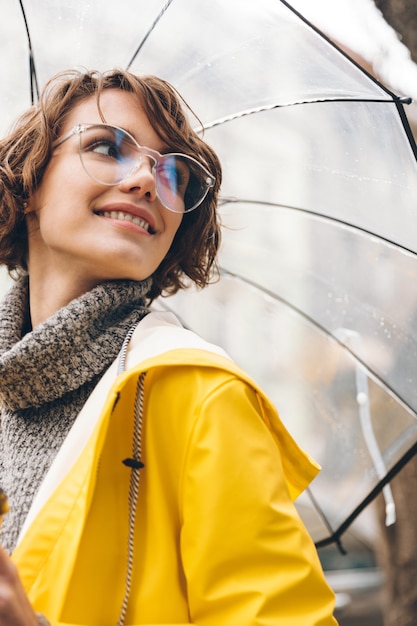 Beautiful young woman dressed in raincoat