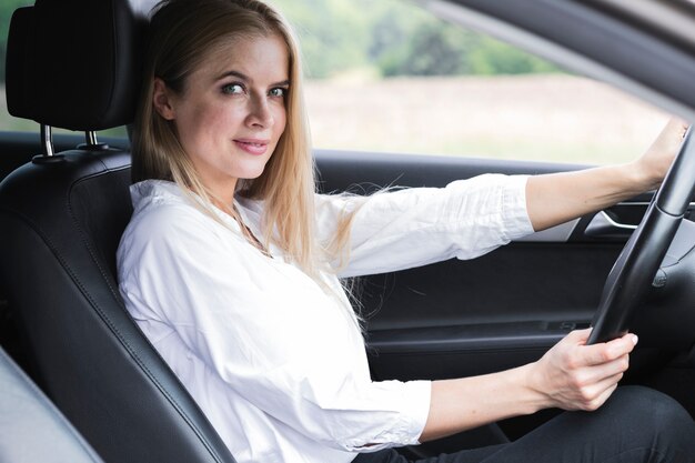 Beautiful young woman driving medium shot