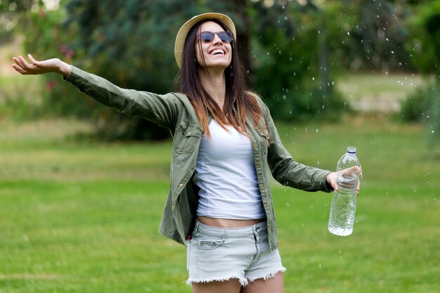 Beautiful young woman enjoying summer with water.