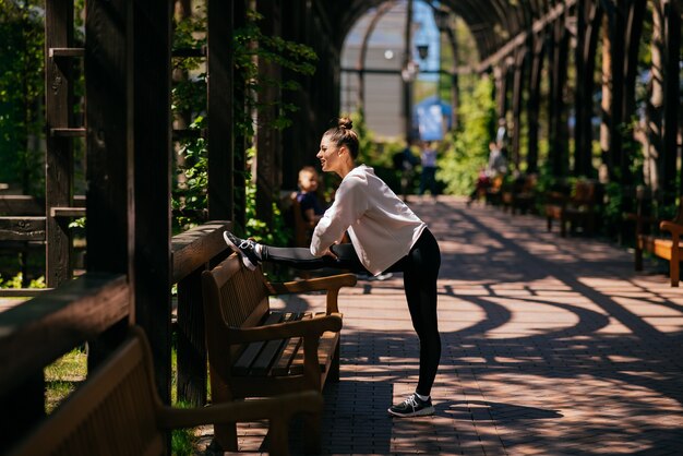 Beautiful young woman goes in for sports in a summer park