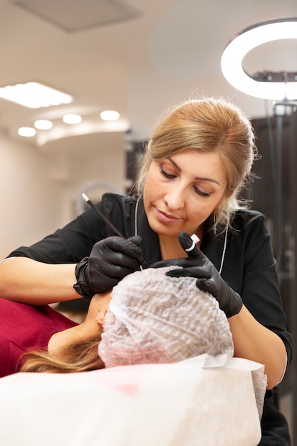 Beautiful young woman going through a microblading treatment