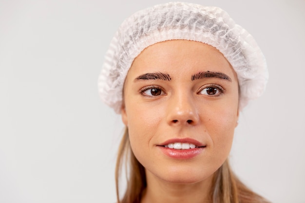 Beautiful young woman going through a microblading treatment