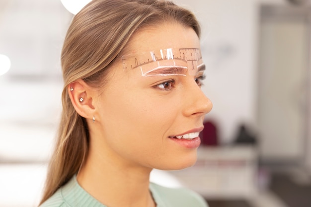 Beautiful young woman going through a microblading treatment