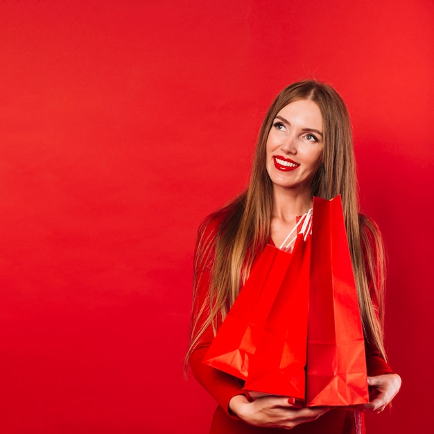 Beautiful young woman holding bags