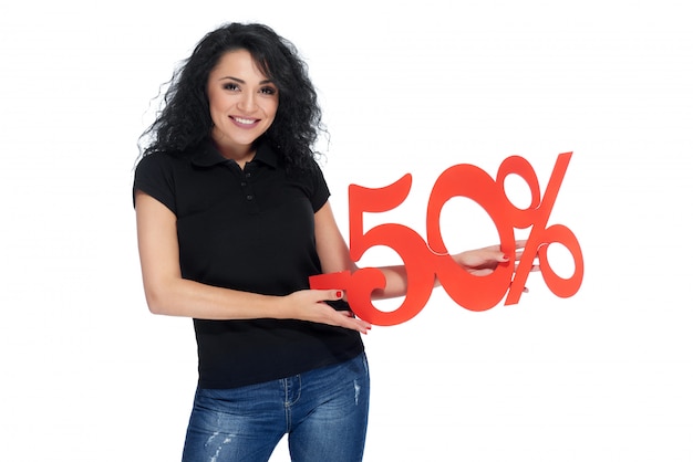 Beautiful young woman holding percentage sign of discount
