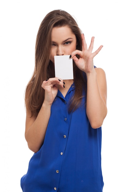 Beautiful young woman holds blank card