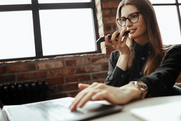 Beautiful young woman in the home office. Working from home. Teleworking concept