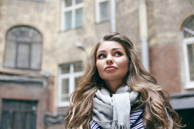 A beautiful young woman is posing outdoor