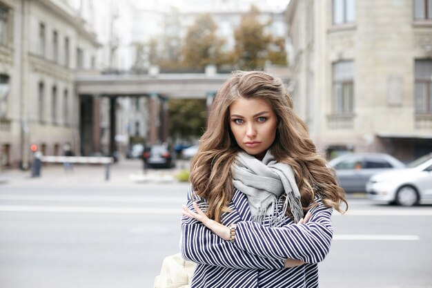 A beautiful young woman is posing outdoor