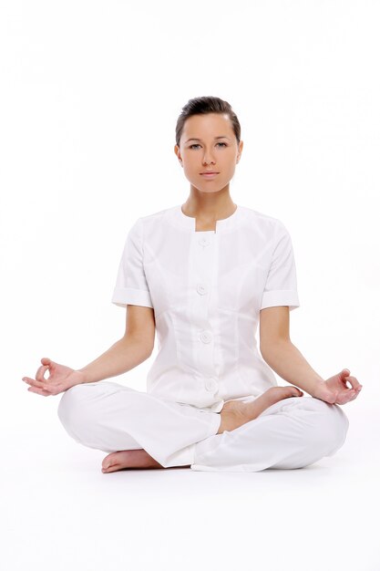 A beautiful young woman in lotus pose