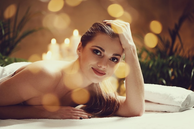 Beautiful young woman lying and waiting for her massage. Spa concept