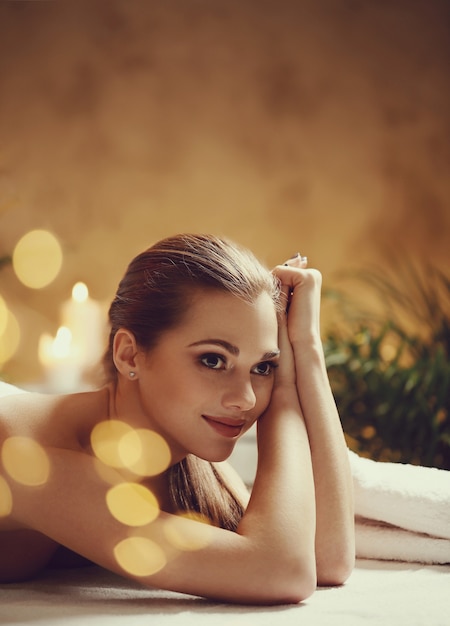 Beautiful young woman lying and waiting for her massage. Spa concept