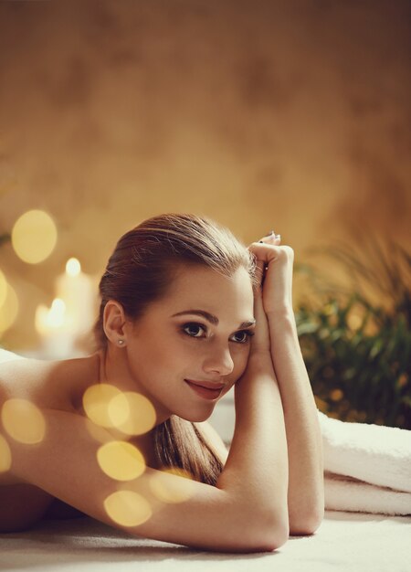 Beautiful young woman lying and waiting for her massage. Spa concept