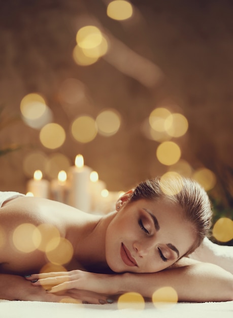 Free photo beautiful young woman lying and waiting for her massage. spa concept