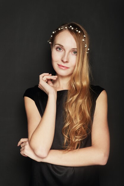 Beautiful young woman portrait on black background