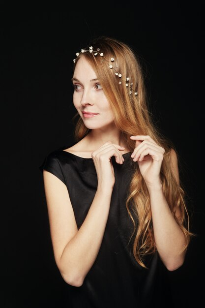 Beautiful young woman portrait on black background