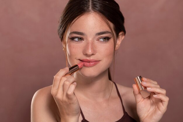 Beautiful young woman portrait with a make-up product