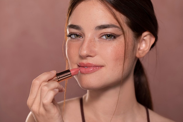 Beautiful young woman portrait with a make-up product