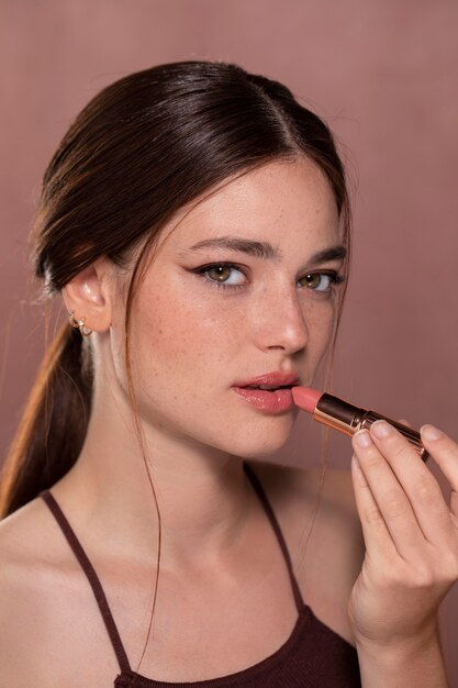 Beautiful young woman portrait with a make-up product