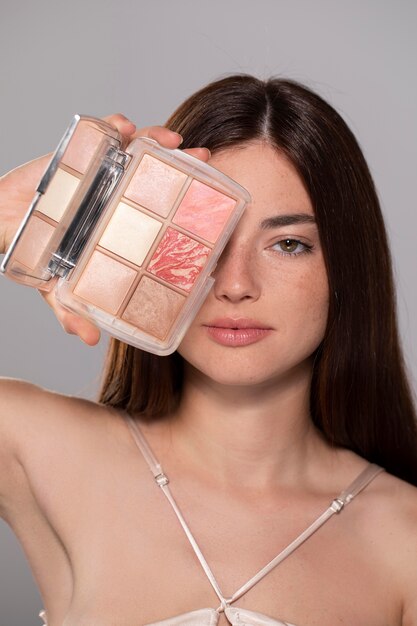 Beautiful young woman portrait with a make-up product