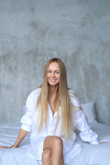 Beautiful young woman posing in the bed