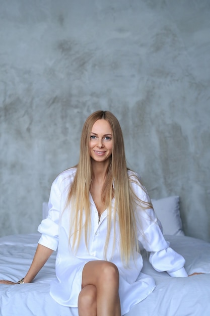 Beautiful young woman posing in the bed