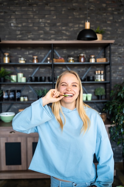 Beautiful young woman posing in the kitchen