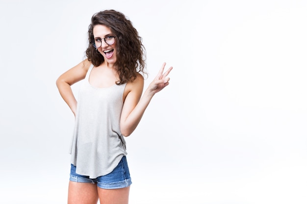 Beautiful young woman posing and looking at camera over white background.