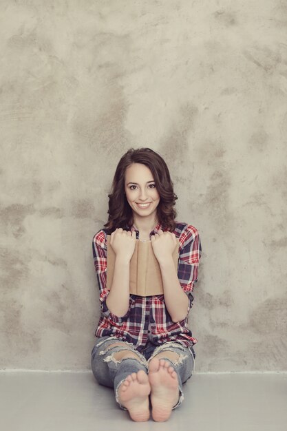 Beautiful young woman posing with book