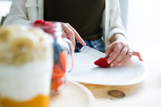 Beautiful young woman preparing breakfast at home.