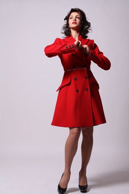 Beautiful young woman in red coat