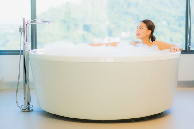 Beautiful young woman relaxing in bathtub