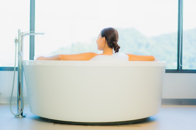 Beautiful young woman relaxing in bathtub