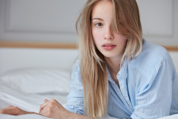 Beautiful young woman relaxing in bed