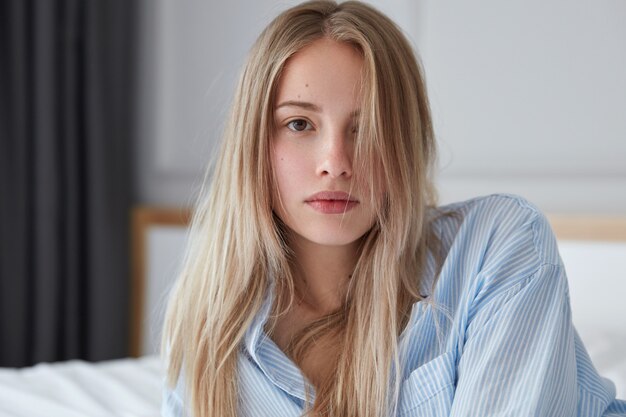 Beautiful young woman relaxing in bed