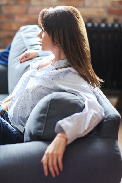 Beautiful young woman relaxing in the sofa