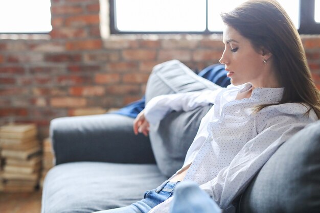 Beautiful young woman relaxing in the sofa