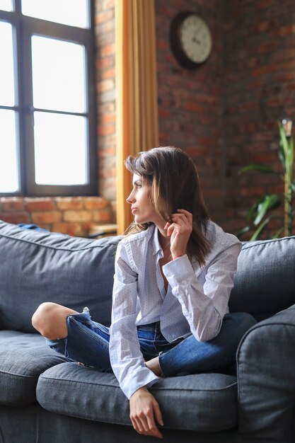 Beautiful young woman relaxing in the sofa