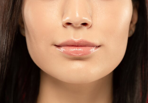 Beautiful young woman's full lips close-up shot.