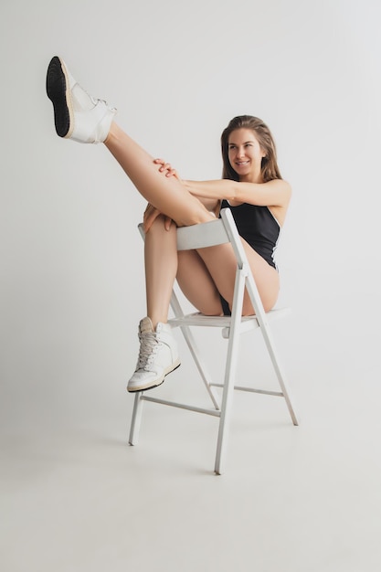 Beautiful young woman's portrait isolated on grey studio