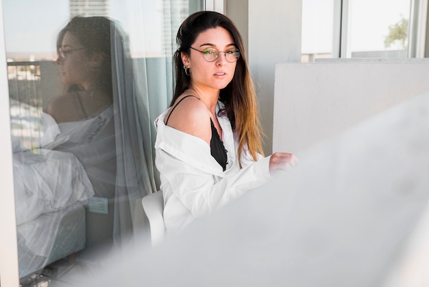 A beautiful young woman sitting in the balcony