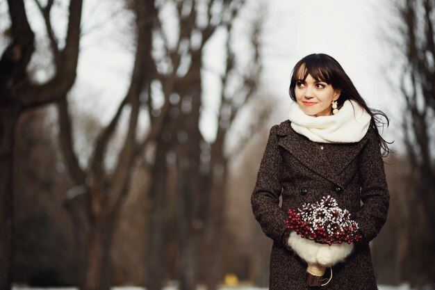 Beautiful and young woman standing in the park alone