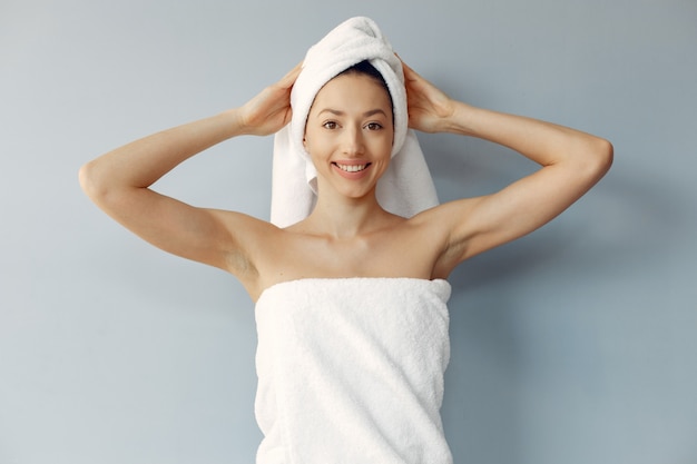 Beautiful young woman standing in a towel