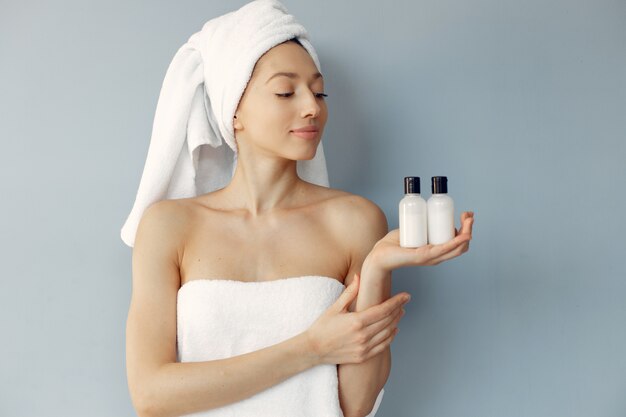 Beautiful young woman standing with cream