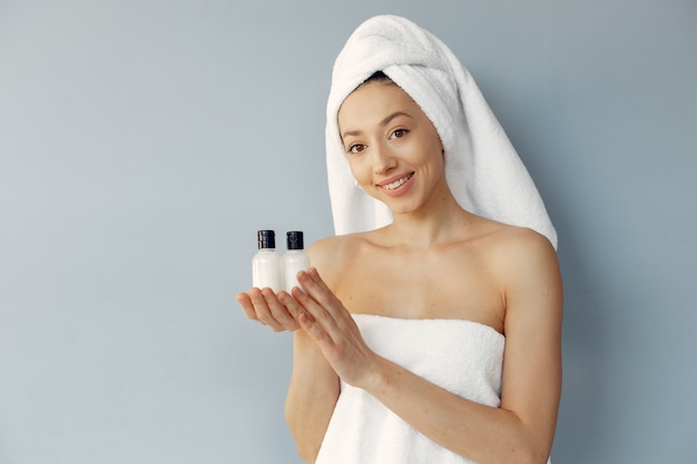 Beautiful young woman standing with cream