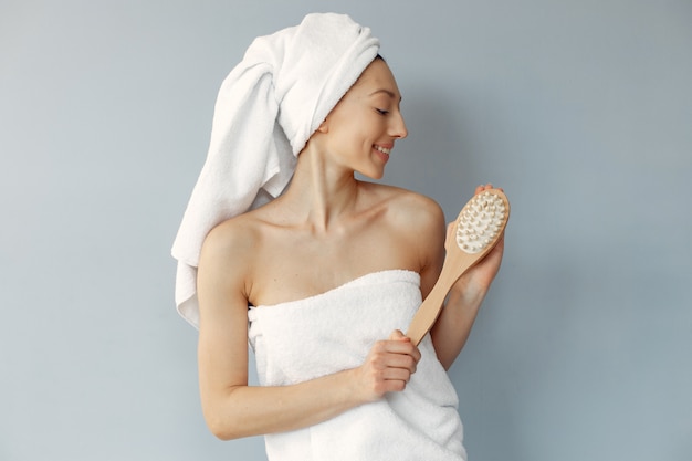 Beautiful young woman standing with massage brush