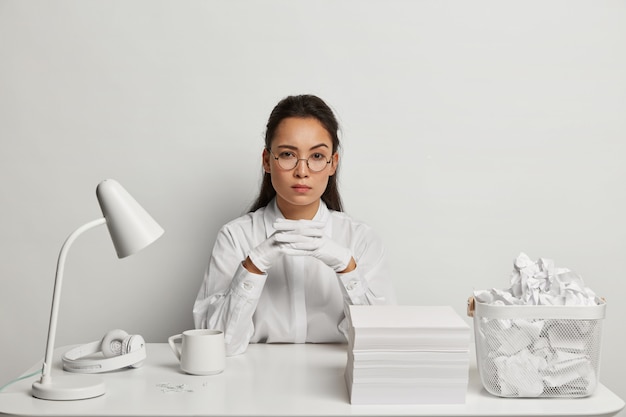 Beautiful young woman studying at her desk